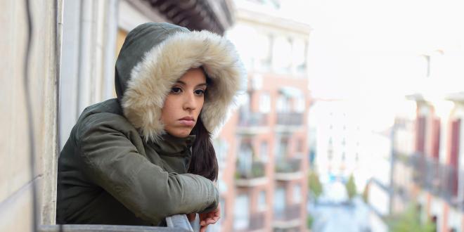 a depressed woman looking out at the city