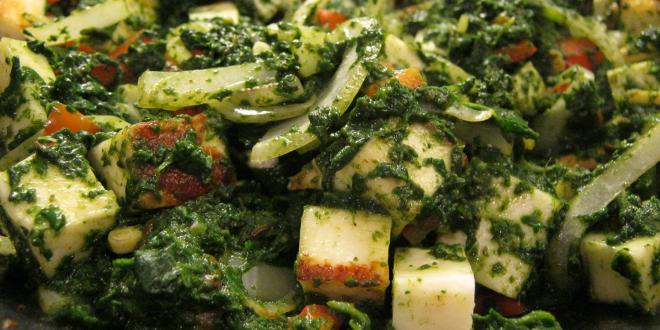 a pan of spinach and cooking cheese