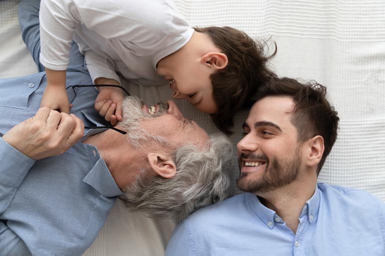 three generations of men laughing together