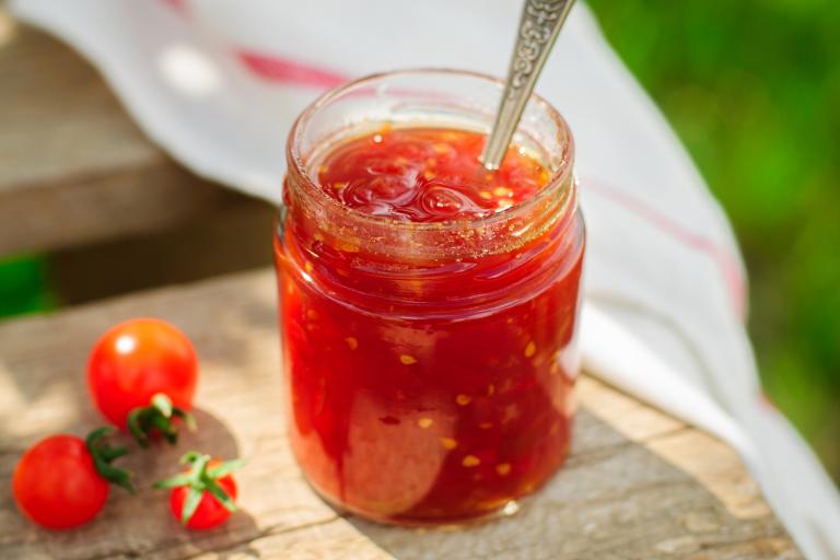 a mason jar full of reduced tomatoes